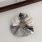 Gifty scrunchie displayed flat showing full patchwork plaid design