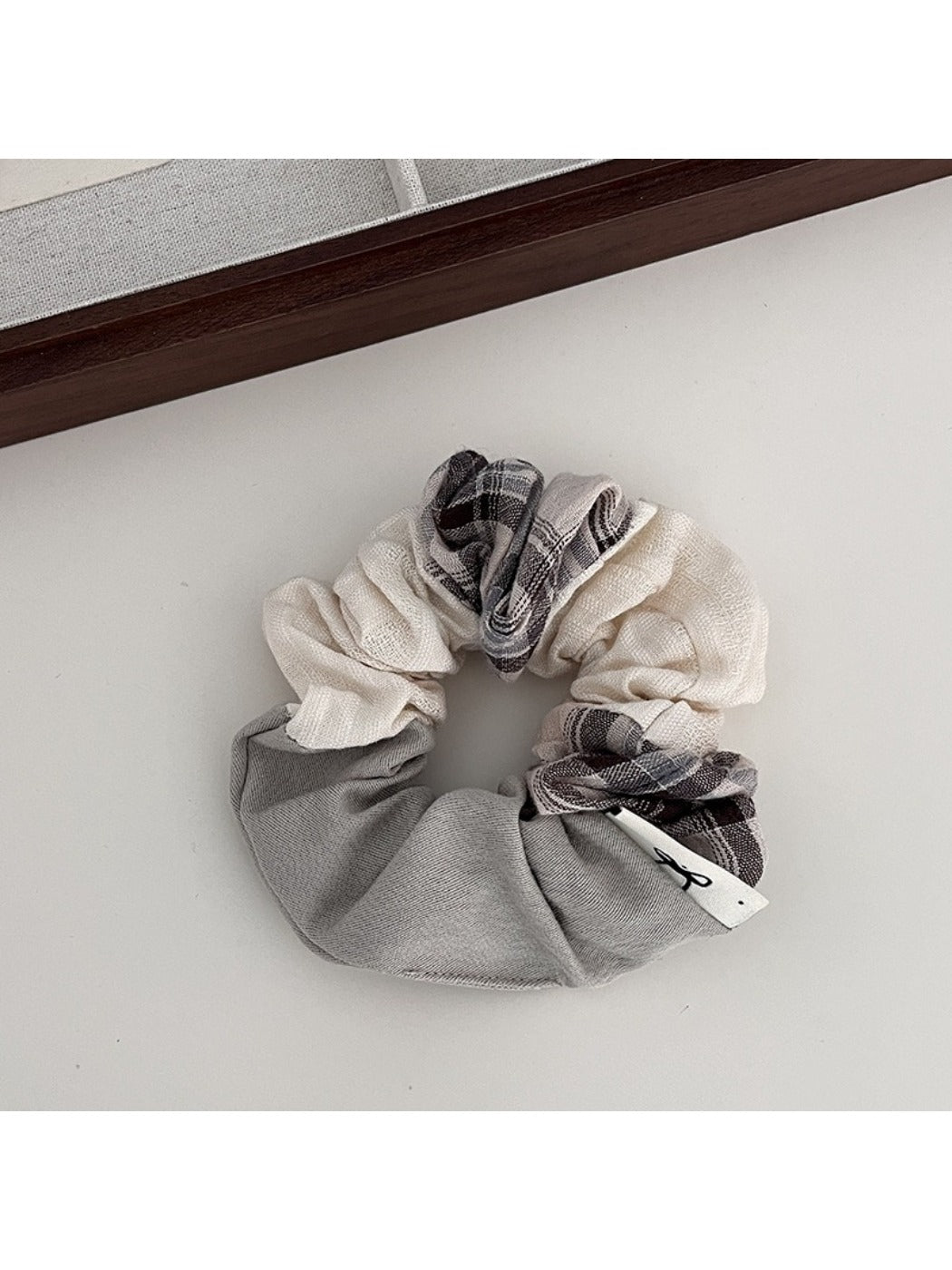 Gifty scrunchie displayed flat showing full patchwork plaid design