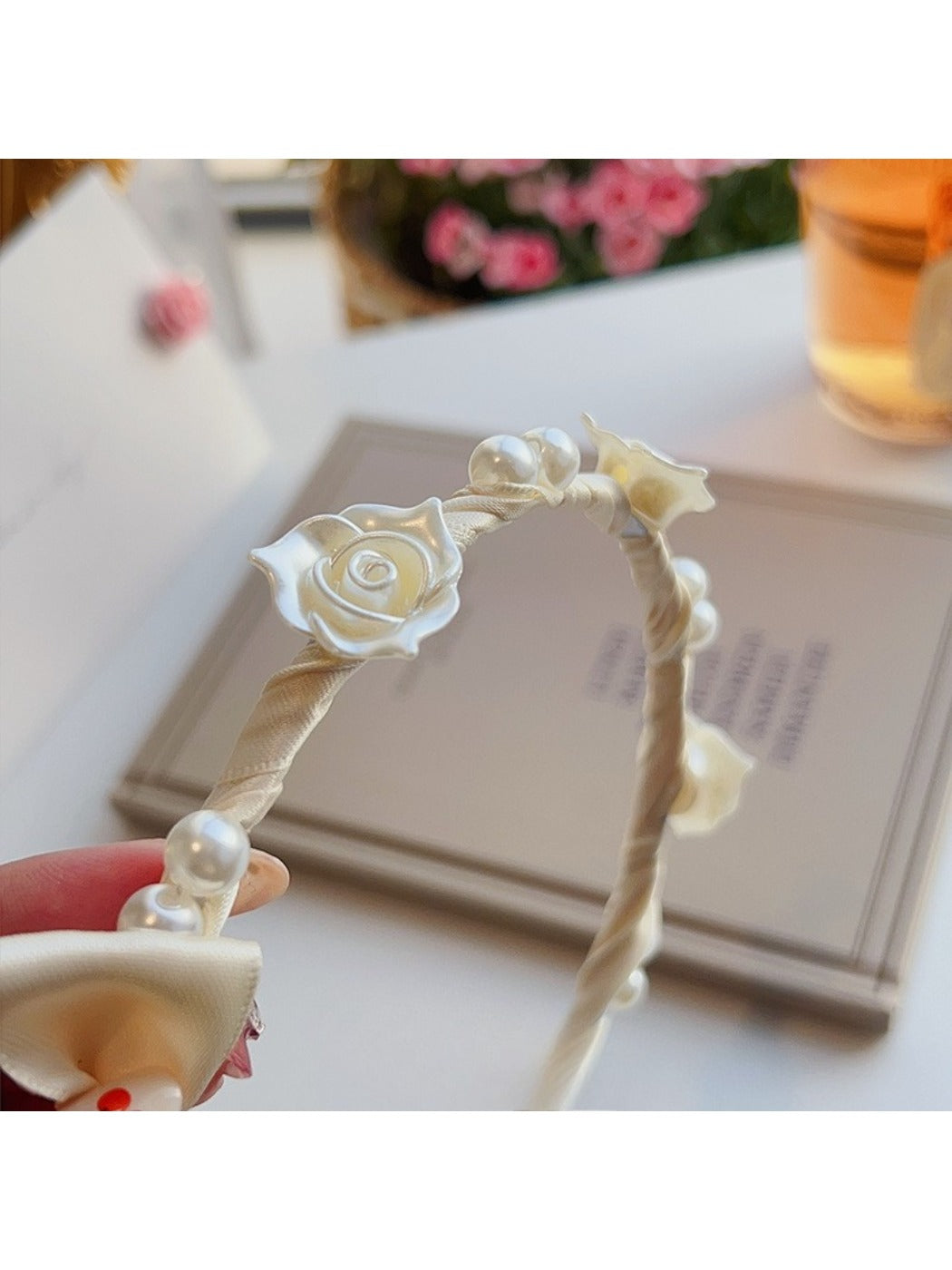 Side view of the soft white headband showing its smooth texture