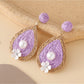 Earedge chic teardrop drop earrings displayed on black velvet pad