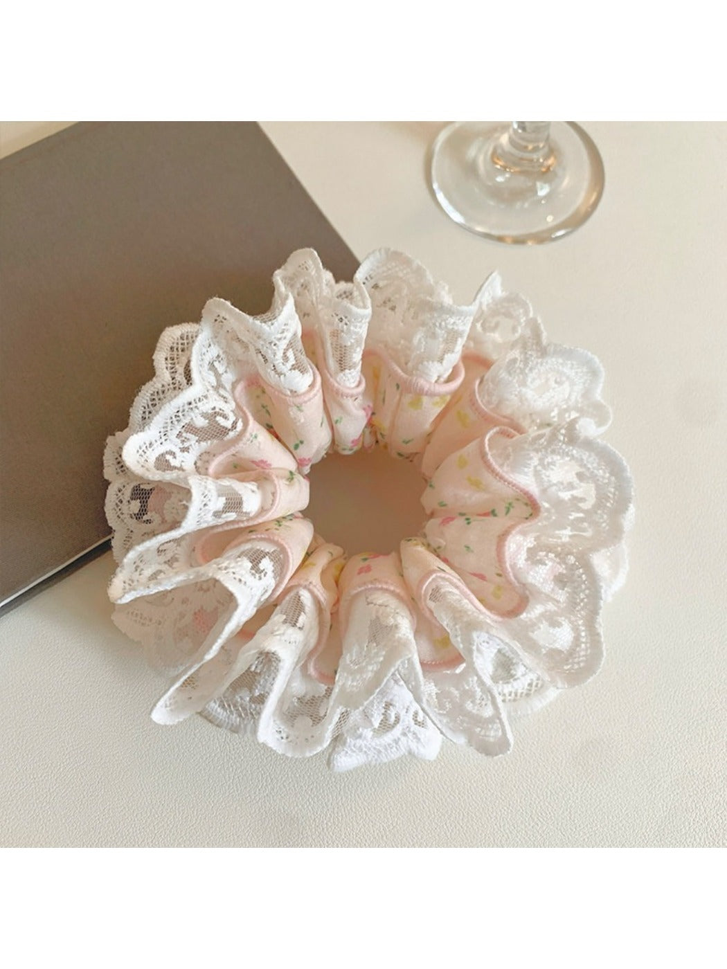 Gifty light pink scrunchie displayed on a wooden surface