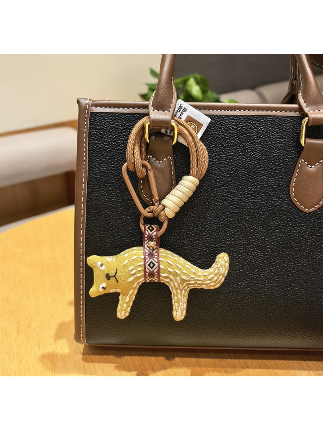 Fox charm keychain displayed with a gift box and ribbon