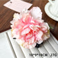 Model wearing Beau lifelike peony flower claw clip styled in loose hair