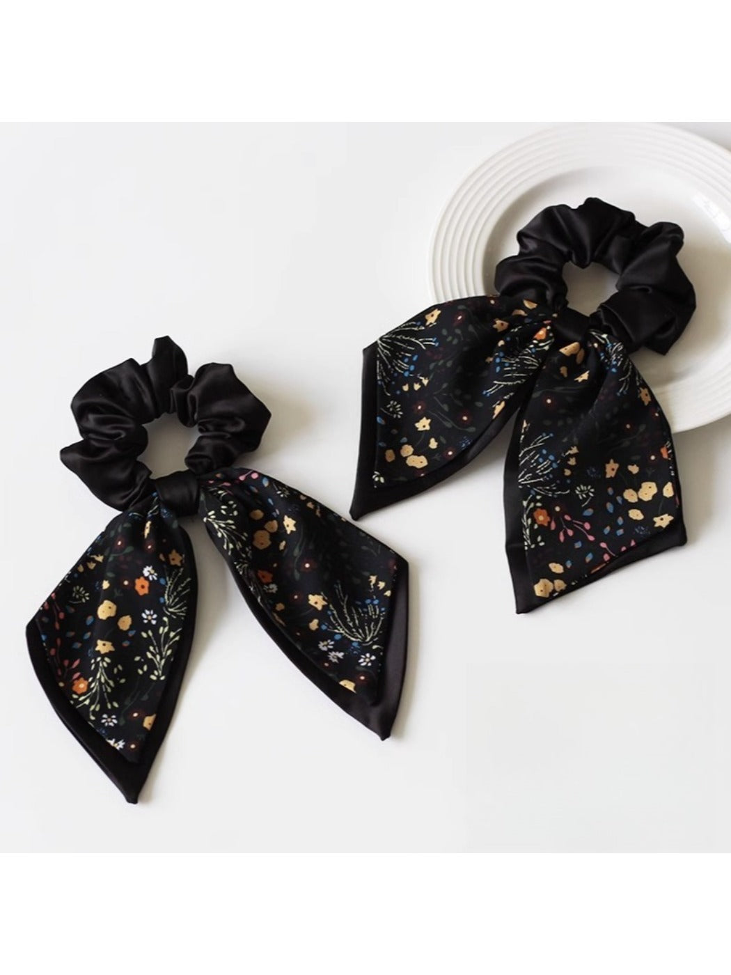 Model wearing Gifty printed bow hair tie styled in a ponytail
