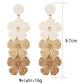 Side view of colorful Bohemian drop earrings with layered shapes and gold accents