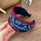 Flat lay of Gifty bohemian headband on wooden surface with flowers