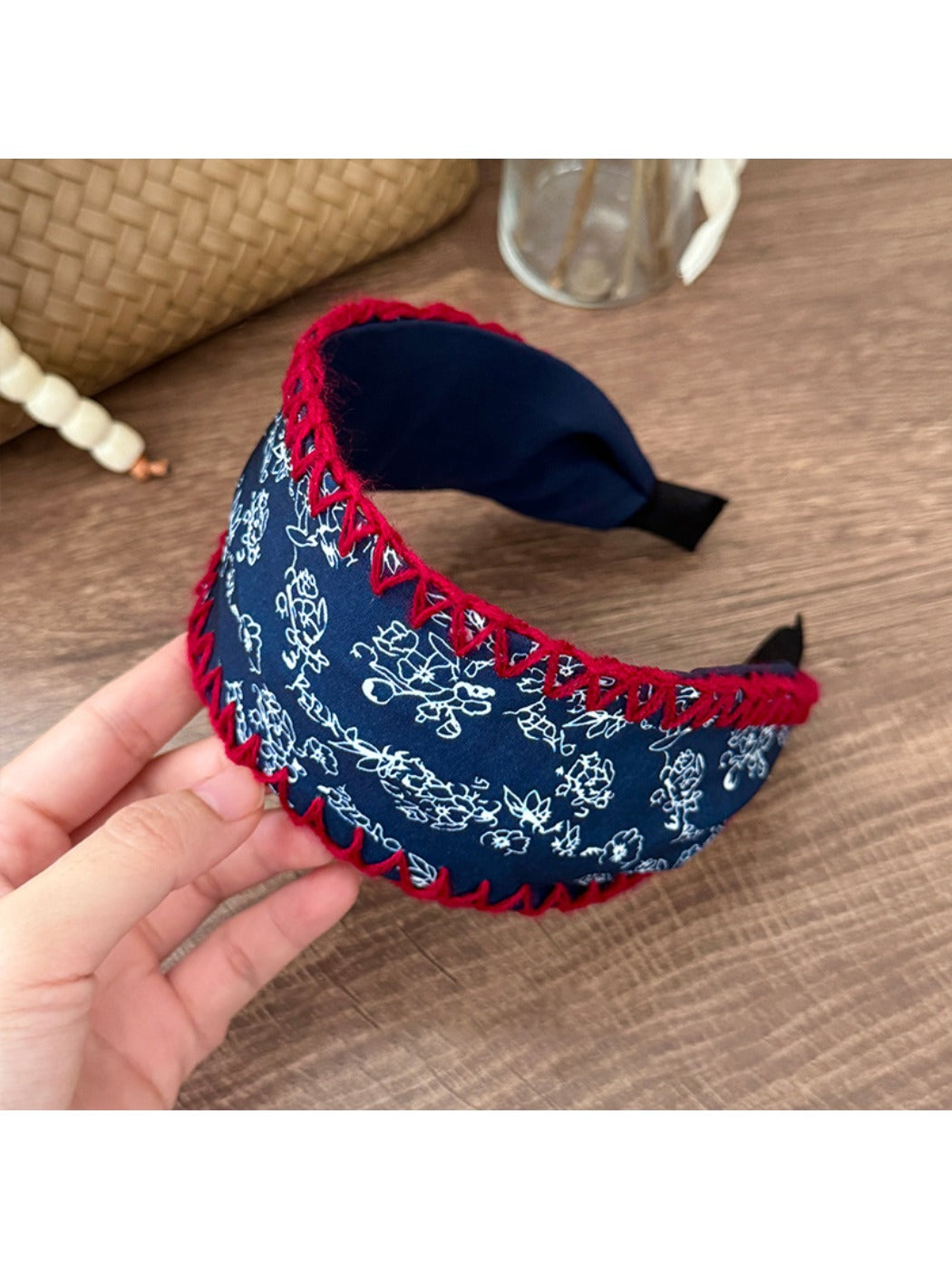 Flat lay of Gifty bohemian headband on wooden surface with flowers