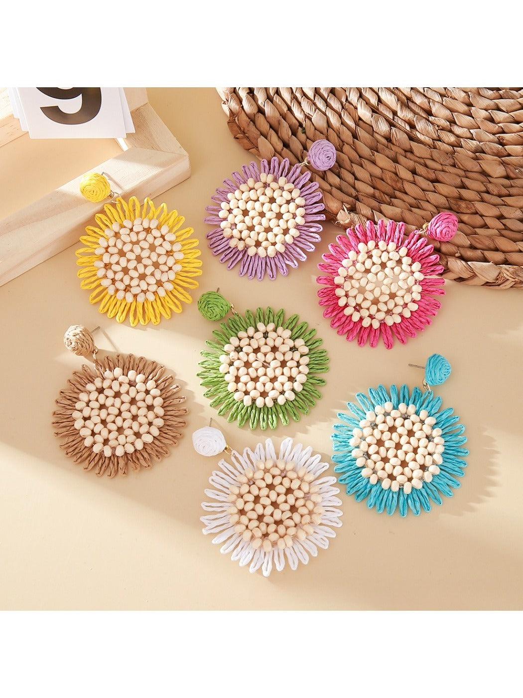 Close-up of elegant sunflower shaped drop earring with gold petals and center