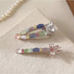 Close-up of Beau colorful hair clip showing layered pastel petals and gold clip base