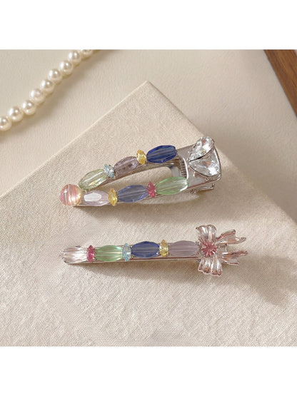 Close-up of Beau colorful hair clip showing layered pastel petals and gold clip base