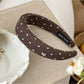 Star hairband shown from an angle emphasizing the band’s thickness and star embellishment