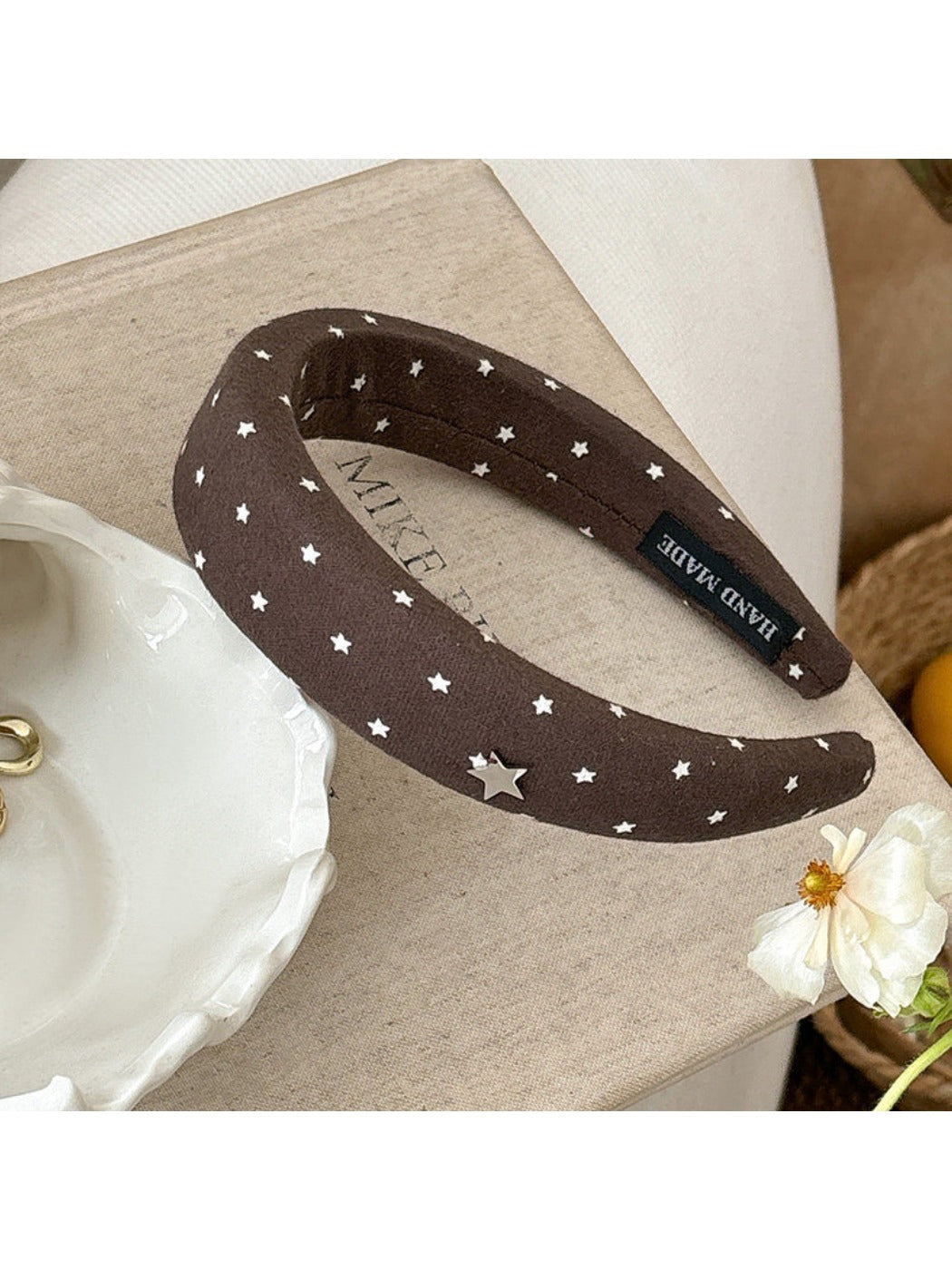 Star hairband shown from an angle emphasizing the band’s thickness and star embellishment