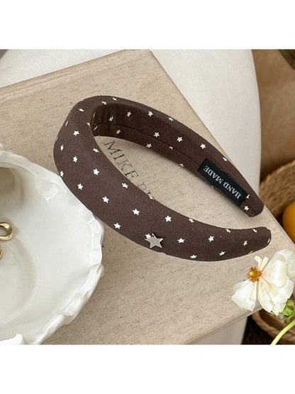 Star hairband shown from an angle emphasizing the band’s thickness and star embellishment