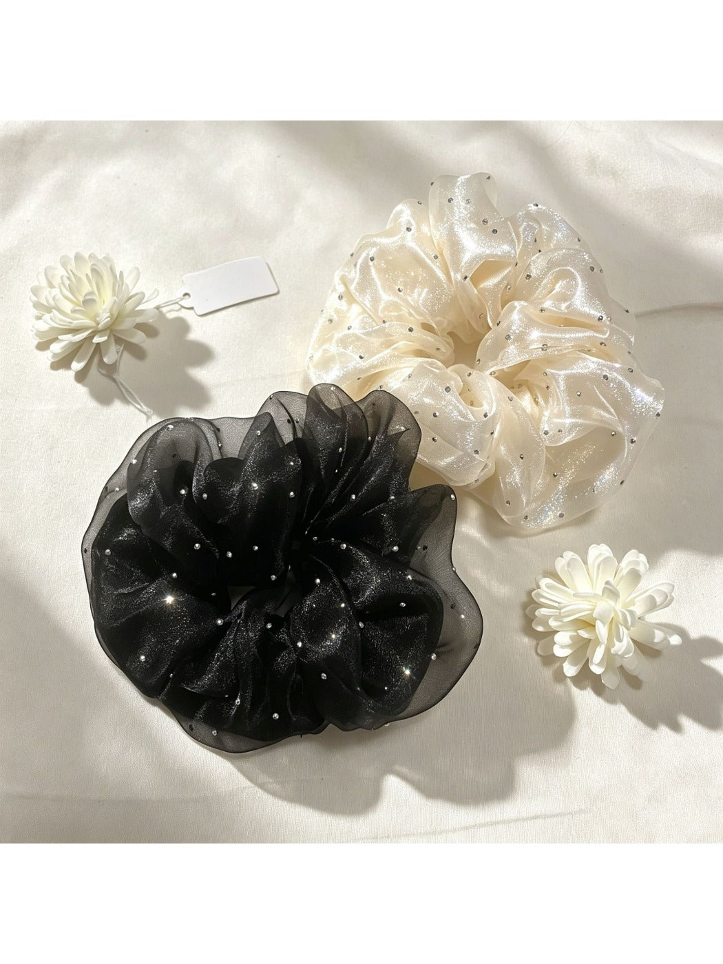 Close-up of Gifty rhinestone embellished tulle scrunchie in soft pink