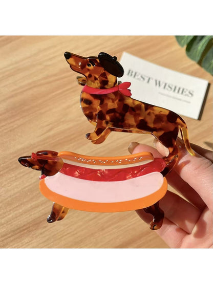 Beau dachshund claw clip held in hand to show size and scale