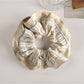 Gifty pastel scrunchie worn in hair, showcasing its gentle pastel tones and volume