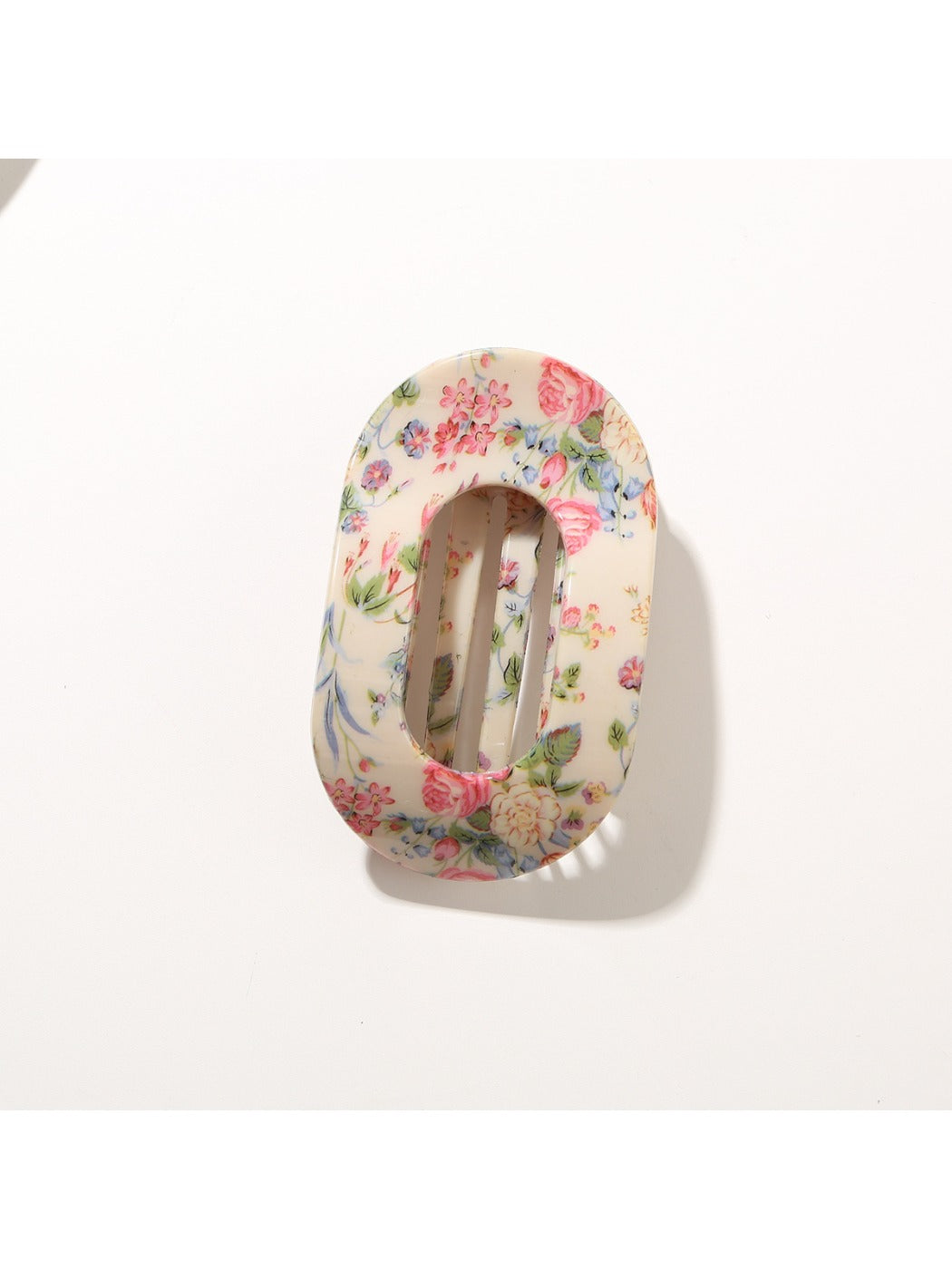 Beau hair clip placed on wooden surface emphasizing vibrant colors and design