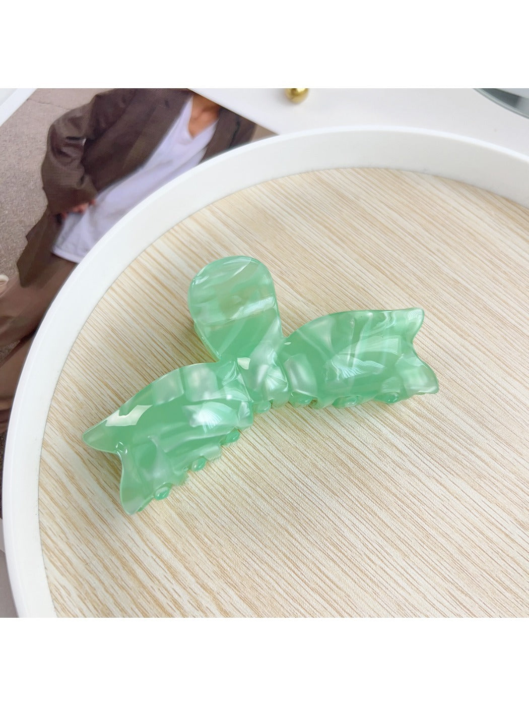Beau hair claw clip styled in model's hair securing a half-up hairstyle