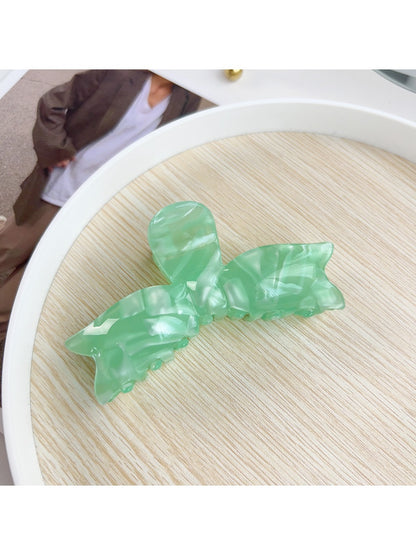 Beau hair claw clip styled in model's hair securing a half-up hairstyle