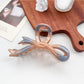 Beau ombre heart shaped bow claw clip shown from multiple angles on a rotating display