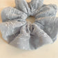 Close-up of Gifty ruffled scrunchie showing fabric texture and ruffle details