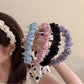 Side view of Gifty minimalist twist headband showing fabric texture