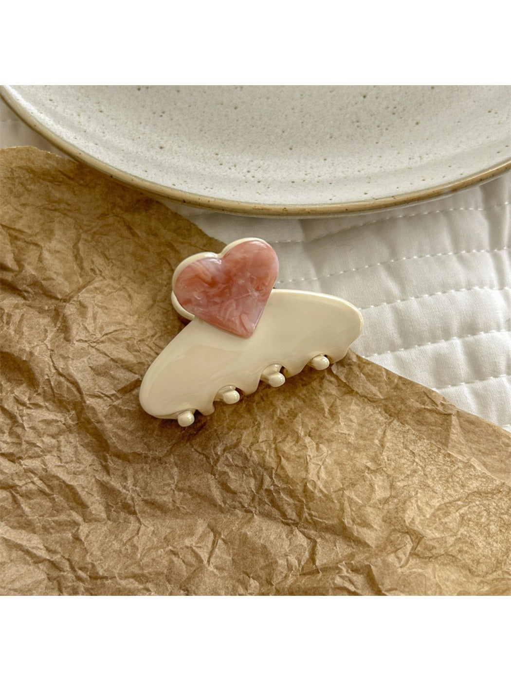 Beau heart shaped acetate claw clip styled in hair to demonstrate use and size