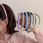 Close-up of Gifty solid color headband showing smooth fabric texture