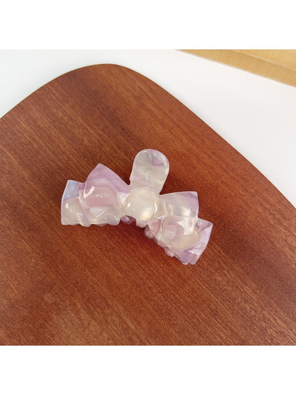 Beau hair claw clip holding thick hair in an elegant updo