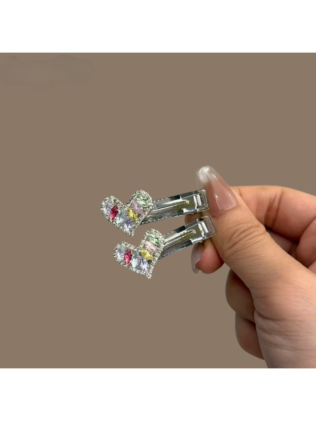 Multiple colorful hair clips displayed in a fan shape on a neutral background