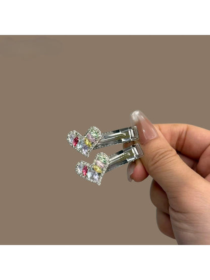 Multiple colorful hair clips displayed in a fan shape on a neutral background