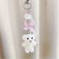 Top view of Keypus flocked bear keychain showing rounded ears and face