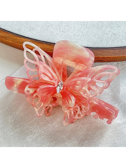 Beau hair claw clip styled in long hair with butterfly decoration visible