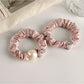 Strawberry hair tie displayed on a white background showing the elastic band