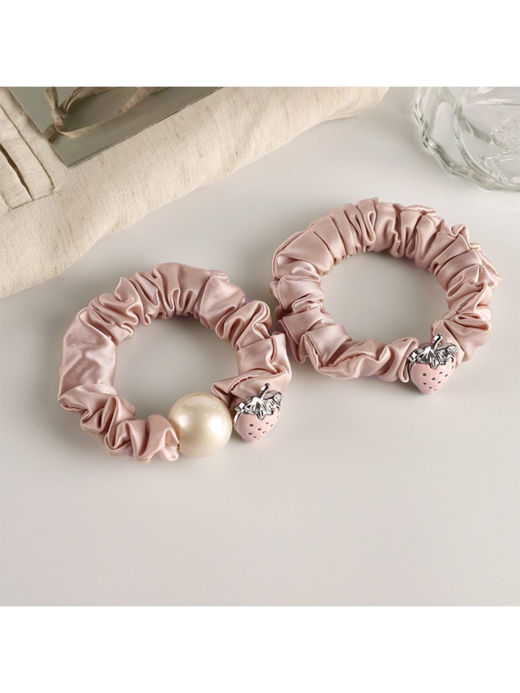 Strawberry hair tie displayed on a white background showing the elastic band
