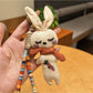 Side view of silver rabbit charm attached to a round keyring