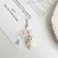 Keypus bear keychain displayed with other colorful bag charms