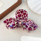 Beau leopard print bow hair claw clip angled to show clasp mechanism