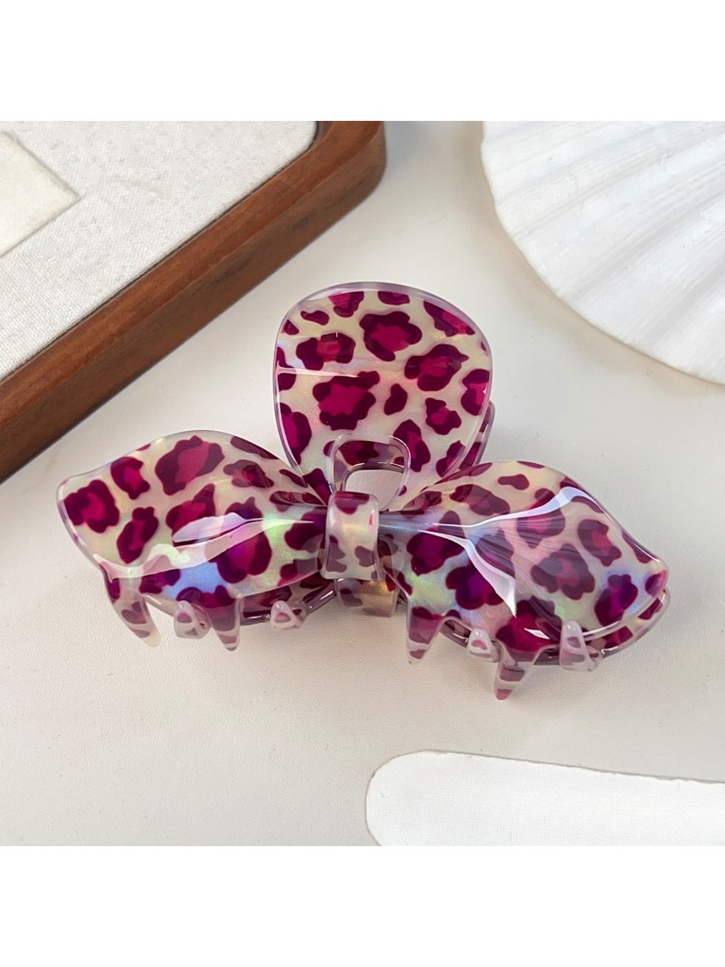 Beau leopard print bow hair claw clip angled to show clasp mechanism