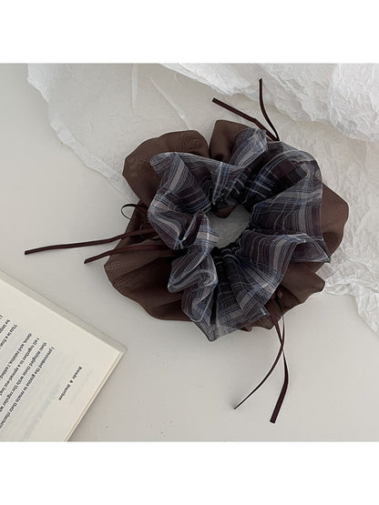 Gifty vintage plaid tulle scrunchie styled on a wrist with a neutral background