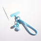 Heart-shaped keychain in pastel colors displayed on a light blue background