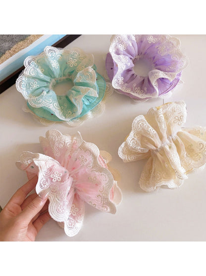 Close-up of Gifty polka dot lace double layer scrunchie showing fabric texture and lace details