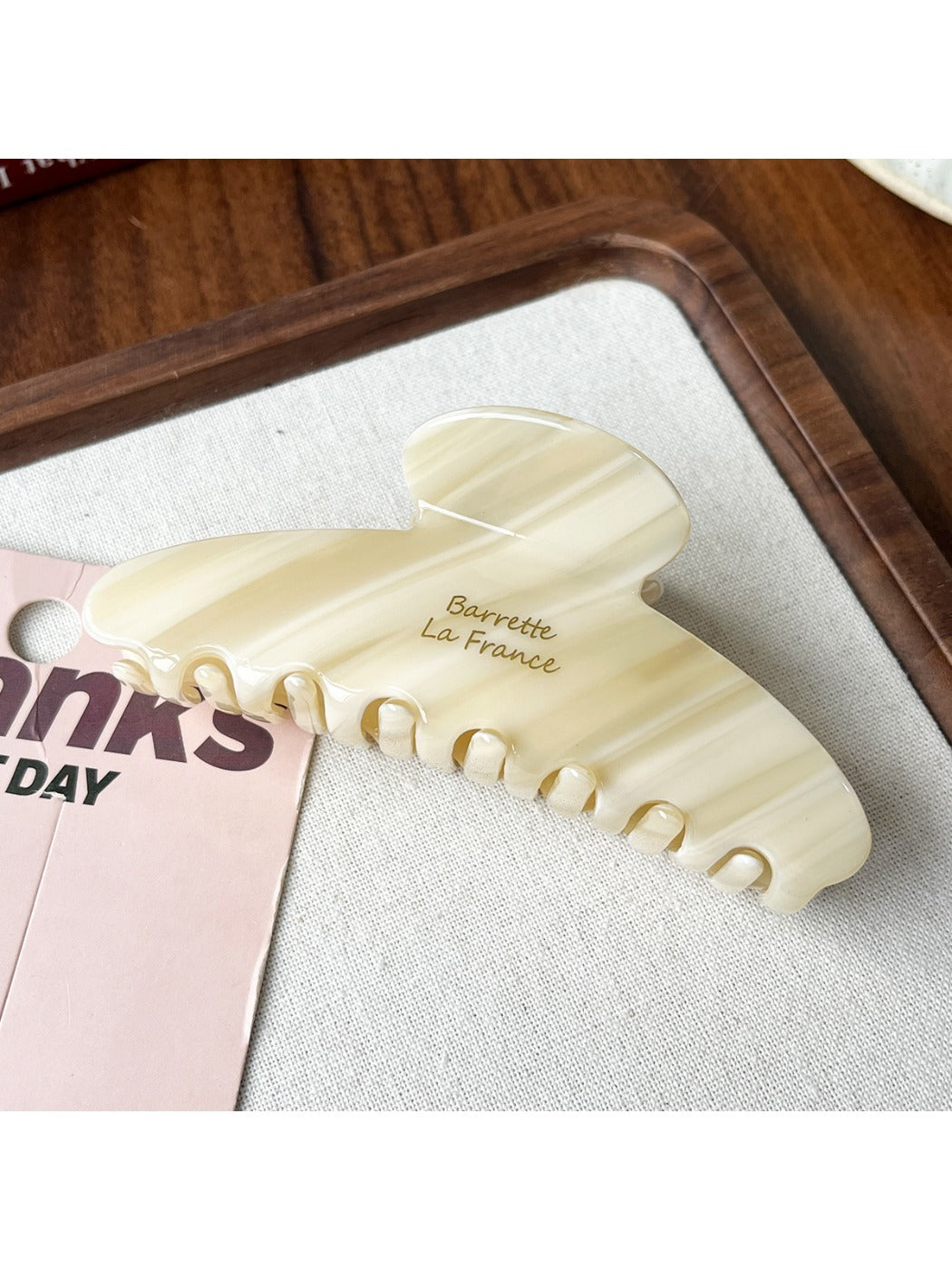 Beau claw clip resting on a wooden surface with soft natural lighting