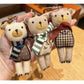 Close-up of fabric bear cub keychain showing stitched facial details