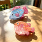 Beau claw clip in pastel pink with sea animal shape on white background