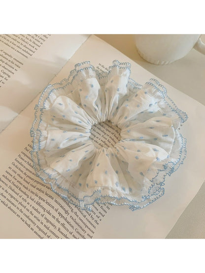 Close-up of ruffled polka dot scrunchie showing fabric texture