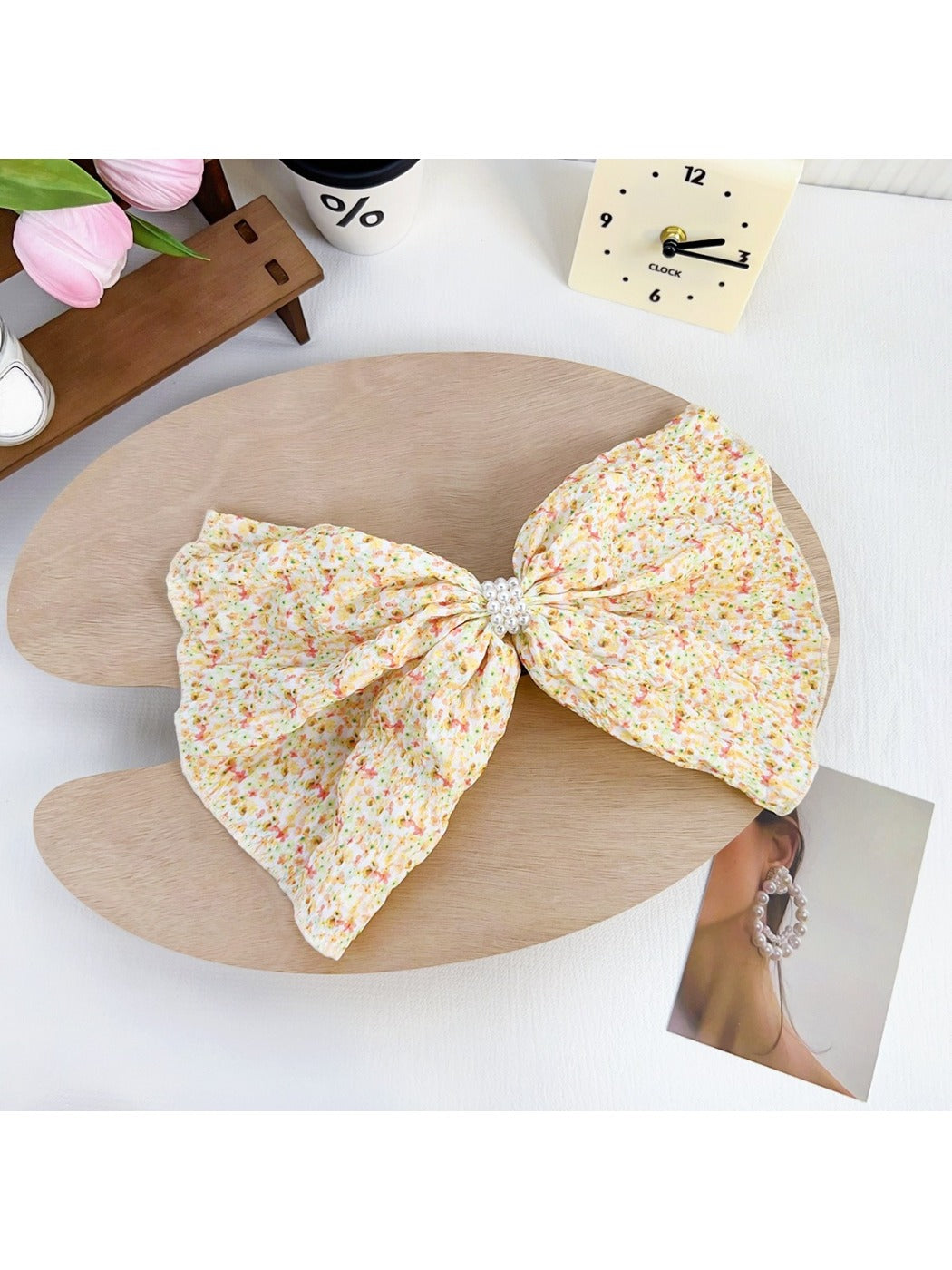 Beau Polka Dot Bow Claw Clip worn in hair, styled in a bun