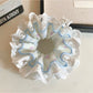 Gifty floral lace scrunchie displayed on a white background showing texture