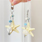 Ocean-themed keychain featuring a starfish and small fish charm on a metal ring