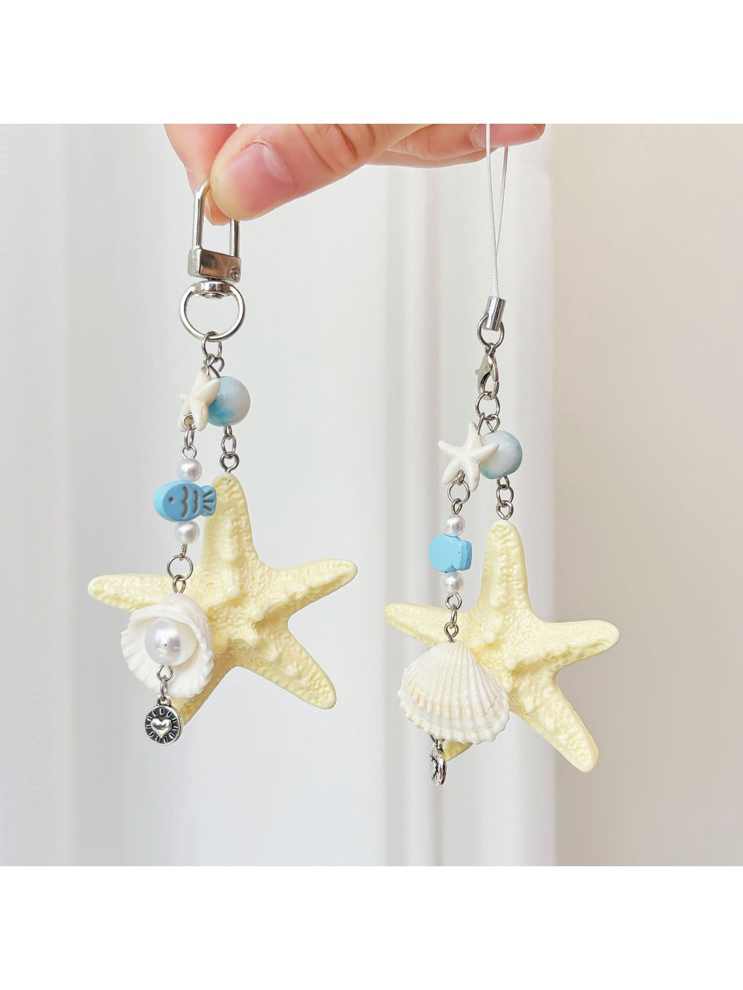 Ocean-themed keychain featuring a starfish and small fish charm on a metal ring